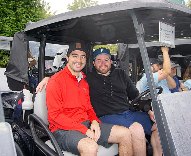 men on golf cart