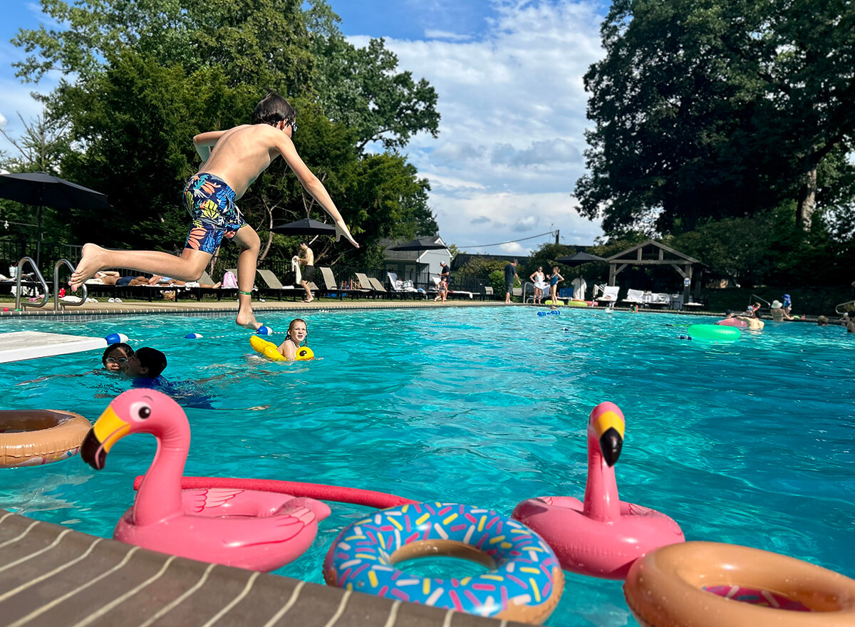 boy jumping into the pool
